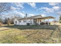 Ranch-style home with two ATVs under the covered parking area at 1209 Austin Chaney Rd, Wingate, NC 28174