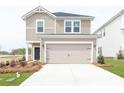 Two-story house with beige siding, a two-car garage, and landscaping at 1212 31St Ne St, Conover, NC 28613