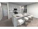 Modern kitchen with island, white cabinets, and stainless steel appliances at 1212 31St Ne St, Conover, NC 28613