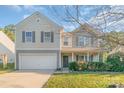 Two-story house with beige siding, a gray door, and manicured landscaping at 1219 Century Dr, Clover, SC 29710