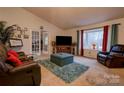 Comfortable living room with vaulted ceilings, large bay window, plush seating, and french doors at 1304 Cambridge Dr, Shelby, NC 28152