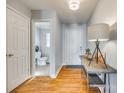 Light and airy entryway with hardwood floors, half-bathroom, and console table at 1309 Winding Branch Ct, Charlotte, NC 28216