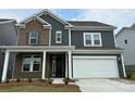 Two-story home with brick and gray siding, white trim, and a two-car garage at 1482 Hubert Graham Way, Tega Cay, SC 29708