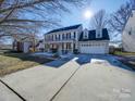 Two-story house with a front porch and attached garage, long driveway and landscaped lawn at 156 Elrosa Rd, Mooresville, NC 28115