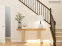 Light and airy entryway with a wooden console table and dark wood railing at 1602 Croyden St, Indian Land, SC 29707