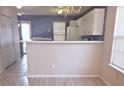 Kitchen with breakfast bar, white cabinets and a view into the dining area at 16740 Timber Crossing Rd, Charlotte, NC 28213