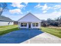 Newly built home featuring a white exterior, covered porch, and concrete driveway at 1715 Pope Ave, Gastonia, NC 28052