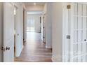 Light and bright hallway with light wood flooring and access to other rooms at 2125 Clifton Rd, Sherrills Ford, NC 28673