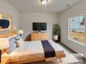 Virtually staged bedroom with large window and modern dresser at 2154 Pheasant Glen Rd, Charlotte, NC 28214