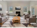 Virtually staged living room featuring fireplace and ample natural light at 2154 Pheasant Glen Rd, Charlotte, NC 28214