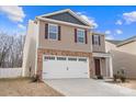 Two-story house with tan siding, brown door, and white garage door at 2262 Redstone Dr, York, SC 29745