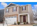 Two-story house with tan siding, brown door, and white garage door at 2262 Redstone Dr, York, SC 29745