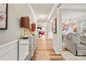 Elegant hallway featuring hardwood floors, crown molding, and neutral paint colors at 3332 Delaware Dr, Denver, NC 28037