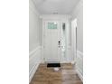 Bright entryway featuring wood floors, modern trim, and a paneled front door with sidelight at 4005 Grace Pointe Dr # 100, Wesley Chapel, NC 28079