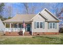 One story house with a green door and white porch at 409 Chinaberry Dr, China Grove, NC 28023