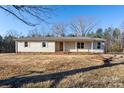 Ranch style home with light beige siding, front door, and small landscaping at 41943 Gurley Rd, New London, NC 28127