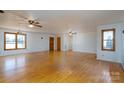 Spacious living room with hardwood floors and two ceiling fans at 41943 Gurley Rd, New London, NC 28127