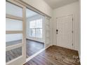 Bright entryway with wood-look floors and sliding glass doors at 4649 Maple Crest Pl, Harrisburg, NC 28075