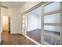 Hallway with sliding glass doors and wood-look floors at 4649 Maple Crest Pl, Harrisburg, NC 28075