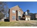 Two-story brick home with a two-car garage and neat landscaping at 5921 Marshbank Ln, Charlotte, NC 28269