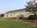 Rear view of house with deck and landscaping at 7104 Sandy Smith Rd, Marshville, NC 28103