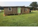 Small wooden outbuilding with green door at 7104 Sandy Smith Rd, Marshville, NC 28103