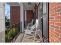 Inviting front porch with rocking chairs and black railing at 819 Lillieshall Rd, Waxhaw, NC 28173