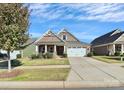 Two-story home with inviting front porch and landscaped lawn at 8243 Bretton Woods Dr, Charlotte, NC 28227