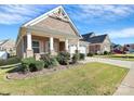 Craftsman style home with a welcoming front porch and landscaping at 8243 Bretton Woods Dr, Charlotte, NC 28227