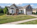 Craftsman style home with stone exterior and lush landscaping at 9124 Longvale Ln, Charlotte, NC 28214