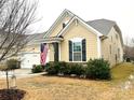 Tan house with a white garage door and American flag at 1009 Chapman St, Indian Trail, NC 28079