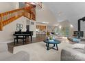 Spacious living room with wood burning stove, cathedral ceilings, hardwood floors, and piano at 10200 Amsterdam Dr, Mount Pleasant, NC 28124