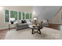 Cozy living room with large windows offering wooded views and neutral decor at 10200 Amsterdam Dr, Mount Pleasant, NC 28124