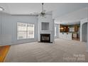 Open living room with a fireplace, high ceilings, and view into kitchen at 1024 Knob Creek Ln, Fort Mill, SC 29708