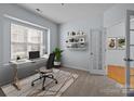 Bright home office features built-in shelving and large window at 1024 Knob Creek Ln, Tega Cay, SC 29708