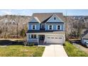 Two-story house with a light blue exterior, double garage, and front porch at 12060 Mariners Cove Ct, Lancaster, SC 29720