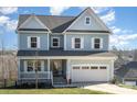 Two-story light blue house with white accents and a double garage at 12060 Mariners Cove Ct, Lancaster, SC 29720