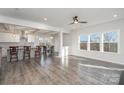 Open kitchen with island, hardwood floors, and white cabinetry at 12060 Mariners Cove Ct, Lancaster, SC 29720