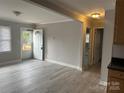 Bright living room with gray walls and laminate wood floors at 1219 Stevens Cir, Gastonia, NC 28054