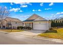 Tan house with a white garage door and driveway at 124 Zolder Ln # 15, Mooresville, NC 28117