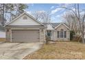 Brick ranch home with gray garage door and landscaped lawn at 14023 Kedleston Rd, Huntersville, NC 28078