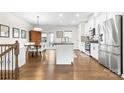 Open concept kitchen with an island, stainless steel appliances, and hardwood floors at 1554 Kee Ct, Charlotte, NC 28203