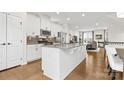 Modern kitchen with white cabinets, granite counters, and stainless steel appliances at 1554 Kee Ct, Charlotte, NC 28203