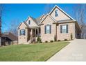 Two-story home with a driveway and landscaped yard at 162 Ravencrest Dr, Statesville, NC 28625