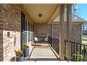 Covered porch with a porch swing and planters at 162 Ravencrest Dr, Statesville, NC 28625