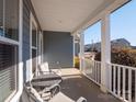 Covered front porch with white columns and seating area at 2056 Angel Oak Dr, Fort Mill, SC 29715