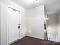 Apartment entryway with white door and carpeted flooring at 2146 S Main St, Kannapolis, NC 28081