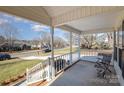 Covered porch with white railings and a wooden chair, offering a relaxing view at 2241 Londonderry Dr, Gastonia, NC 28056