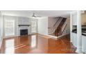 Spacious living room with hardwood floors, a fireplace, and a staircase at 2241 Londonderry Dr, Gastonia, NC 28056