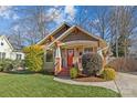 Charming craftsman home with red door and nicely landscaped front yard at 2328 Barry St, Charlotte, NC 28205